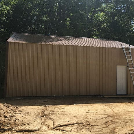 Sanders Construction LLC and Remodeling tan sheet metal building
