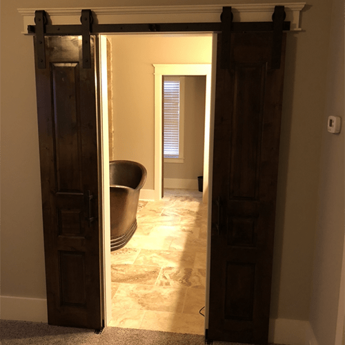 Sanders Construction and Remodeling New Home Barndoor into masterbathroom